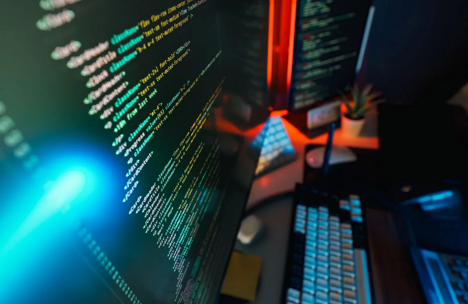 Futuristic workspace featuring a glowing computer screen with coding displayed, ideal for technology and programming concepts.